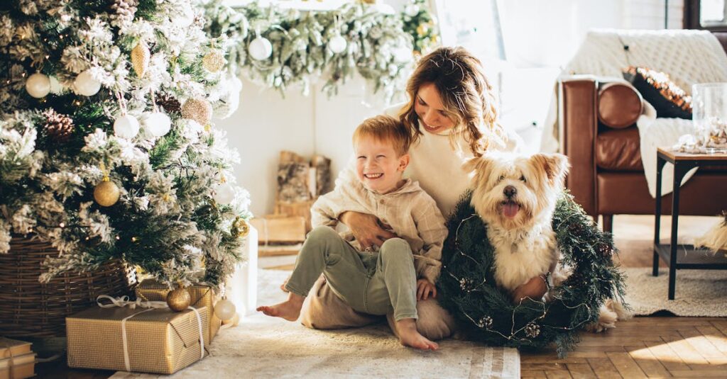 Mother, child, and dog enjoying Christmas morning by the decorated tree at home.